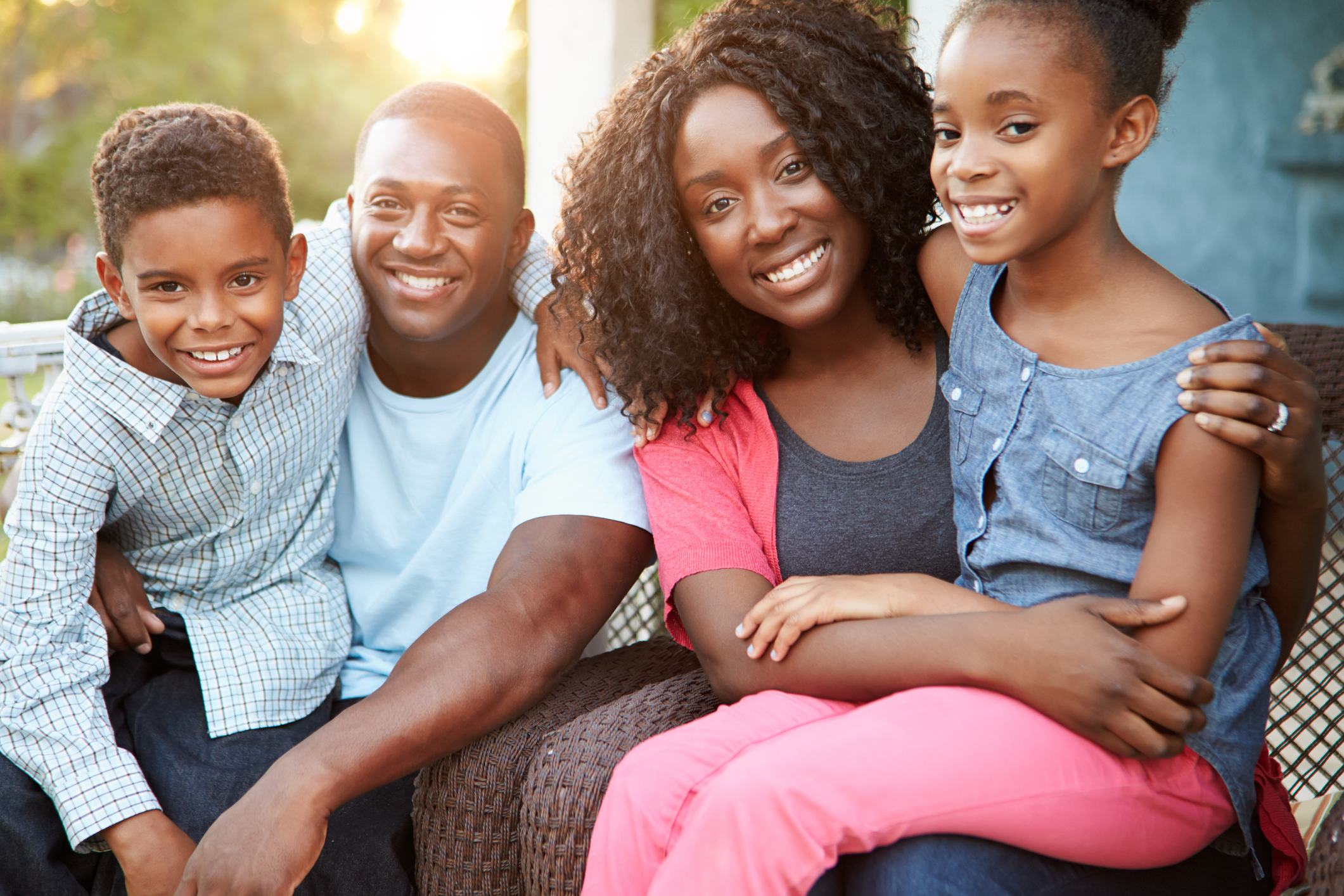 Portrait Of Family Sitting Outside House